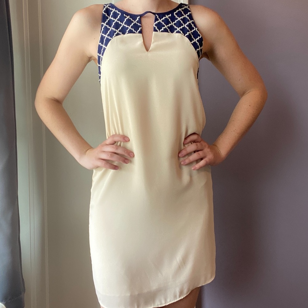 Nude/light tan dress with navy blue accents